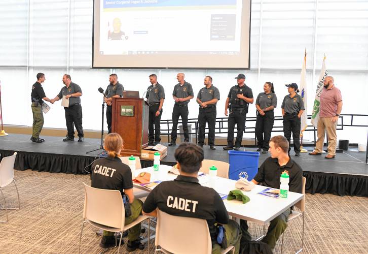 Tommy Nutting, left, is congratulated by Jason Haskins and other advisors of the Franklin County Police Cadet Program for completing the program at Greenfield Community College on Wednesday.