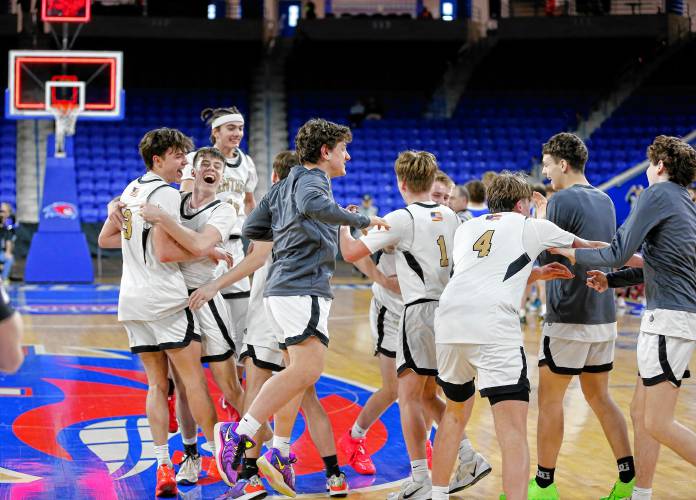 Pioneer players storm the court to celebrate after their 49-28 win over Hopedale for the MIAA Div. 5 state championship Saturday at the Tsongas Center in Lowell. 