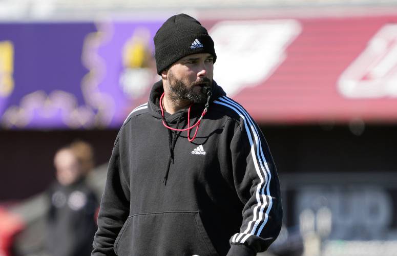 UMass football coach Joe Harasymiak watches practice on Thursday in Amherst. The Minutemen will play their annual spring game on Saturday at McGuirk Alumni Stadium.