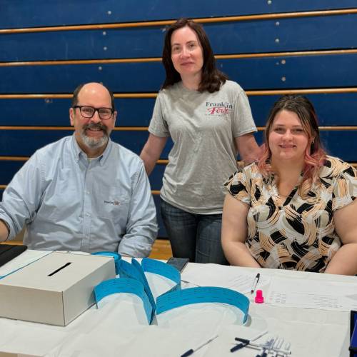 Franklin First Federal Credit Union employees David Howe, Michelle Dwyer and Anna Morin attend a Financial Reality Fair at Franklin County Technical School in April.