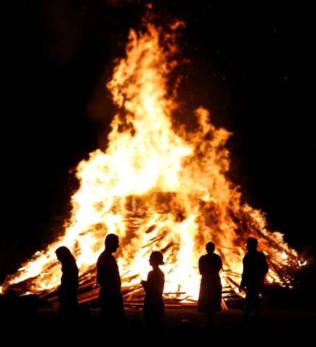 People gather at the Montague Center Ballfield for the annual bonfire in 2019. This year’s event will be held Wednesday, July 3, starting at 6:30 p.m.