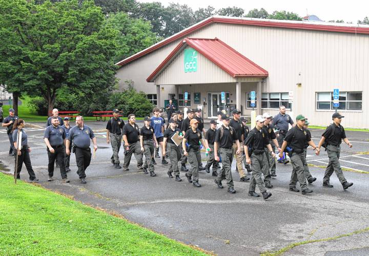 Participants and advisors for the Franklin County Police Cadet Program march in formation at Greenfield Community College on Wednesday.