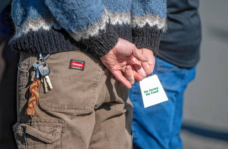 Crowd members hold cowbells during a local farmer rally at Hadley Town Hall, Sunday.