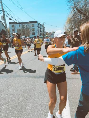 Kate Bitters hugs her mom, Joan, along the course during the 129th Boston Marathon last month. 