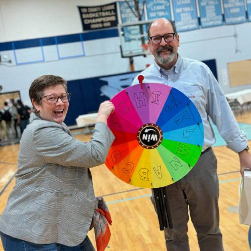 Ericka McGann Almeida of Stout Pigeon Coffee Co. and Franklin First Federal Credit Union employee Dave Howe at a Financial Reality Fair at Franklin County Technical School in April.