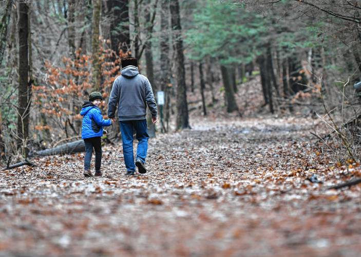 Alan Parpalov, 7, walks with his father, Leo Parpalov, in Highland Park in Greenfield on a recent day. Alan Parpalov, 7, walks with his father, Leo Parpalov, in Highland Park in Greenfield on a recent day.