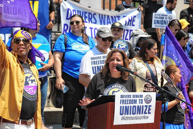Roxana Rivera of 32BJ SEIU speaks at a rally for a union for app-based drivers on Tuesday.