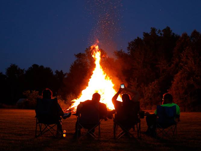 People gather at the Montague Center Ballfield for the annual bonfire in 2019. This year’s event will be held Wednesday, July 3, starting at 6:30 p.m.