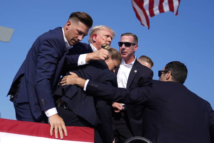Republican presidential candidate former President Donald Trump is surrounded by U.S. Secret Service agents at a campaign rally, Saturday, July 13, 2024, in Butler, Pa. (AP Photo/Evan Vucci)