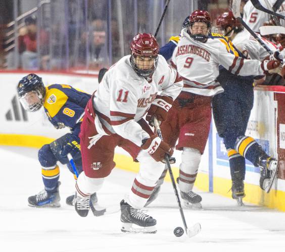 UMass Lucas Mercuri (11) controls the puck during Saturday’s game against Merrimack at the Mullins Center in Amherst.