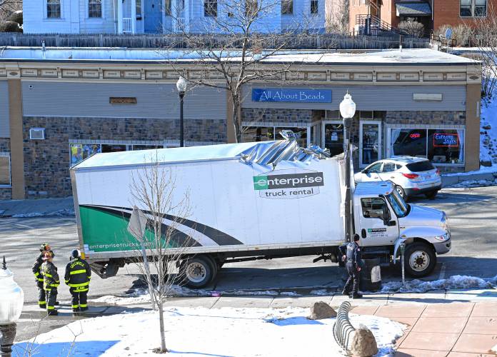 A box truck that was heavily damaged after hitting a bridge is parked on Bank Row in Greenfield on Tuesday.