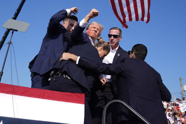 Republican presidential candidate former President Donald Trump is surrounded by U.S. Secret Service agents at a campaign rally, Saturday, July 13, 2024, in Butler, Pa. (AP Photo/Evan Vucci)
