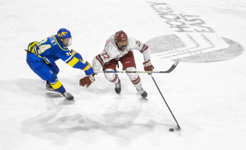 UMass right wing Nick VanTassell (22) keeps the puck from Alaska center Kyle Gaffney, left, during the NCAA hockey game at the Mullins Center, Friday, Jan. 24, 2025, in Amherst.