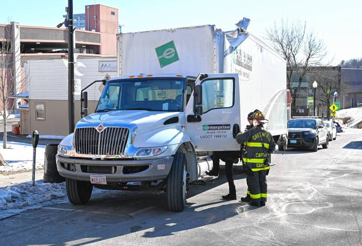 A box truck that was heavily damaged after hitting a bridge is parked on Bank Row in Greenfield on Tuesday.