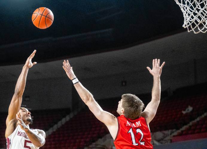 UMass forward Daniel Rivera, left, attempts a shot over Davidson guard Hunter Adam (12) during the college basketball game at the Mullins Center, Wednesday, Feb. 12, 2025, in Amherst.