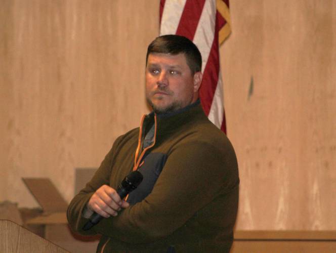 Sam Urkiel, superintendent of the Montague Department of Public Works, stands at the front of the Turners Falls High School auditorium during the second session of Annual Town Meeting on Wednesday. Sam Urkiel, superintendent of the Montague Department of Public Works, stands at the front of the Turners Falls High School auditorium during the second session of Annual Town Meeting on Wednesday.