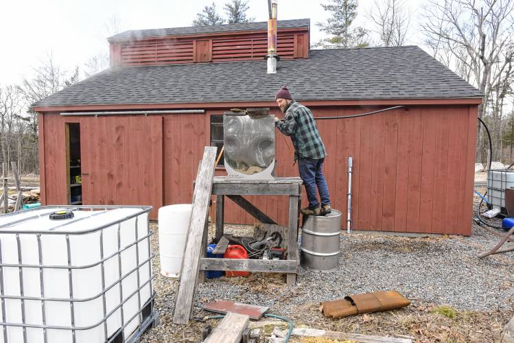 Rich Valcourt of Valcourt Sugar Shack in Petersham checks his standby tank of sap that has been concentrated by his reverse osmosis machine.