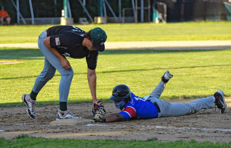 Greenfield first baseman Hugh Cyhowski puts down a tag on a pickoff attempt from pitcher Ben Werner during Post 81’s 5-1 loss to East Springfield Post 420 during an American Legion Senior Division contest on Monday night at Vets Field in Greenfield.