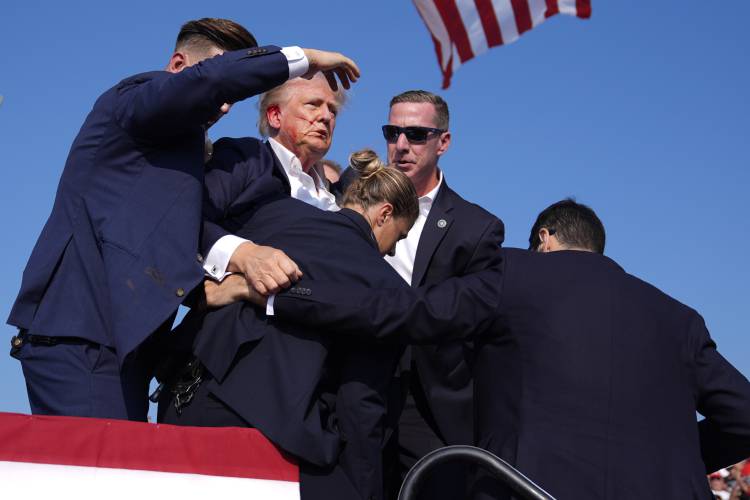 Republican presidential candidate former President Donald Trump is surrounded by U.S. Secret Service agents at a campaign rally, Saturday, July 13, 2024, in Butler, Pa. (AP Photo/Evan Vucci)