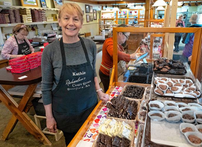 Kathie Williams, owner of Richardson’s Candy Kitchen in Deerfield, with a variety of chocolates and candy.