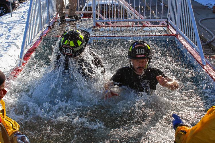 From left, Joseph D’Astous and Evan Geary of the Greenfield Fire Department take the plunge during the Special Olympics Massachusetts fundraising event Thursday afternoon at Greenfield High School.
