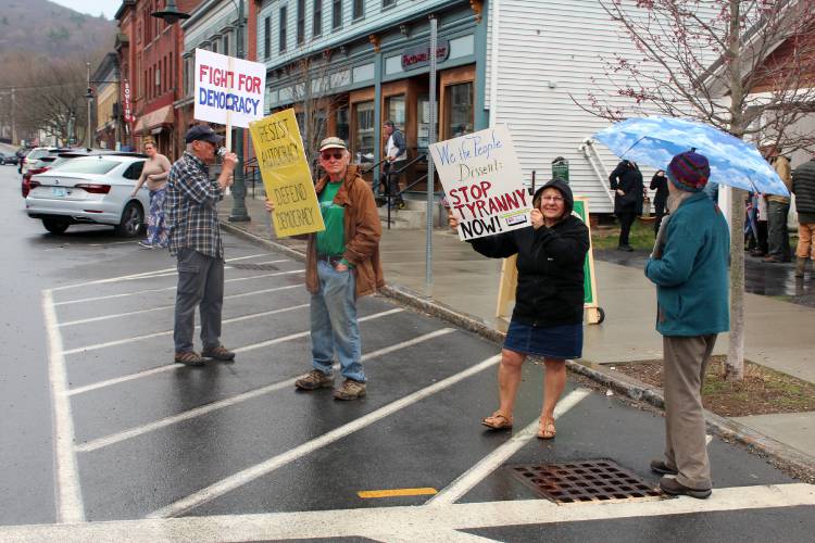 Protesters march through Shelburne Falls in opposition to the Trump administration on Saturday.