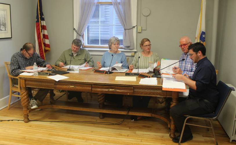 From left, Orange Selectboard Clerk Andrew Smith, member Mike Bates, member Jane Peirce, Vice Chair Julie Davis, Chair Tom Smith and Town Administrator Matthew Fortier sit at a table during Wednesday’s Selectboard meeting. From left, Orange Selectboard Clerk Andrew Smith, member Mike Bates, member Jane Peirce, Vice Chair Julie Davis, Chair Tom Smith and Town Administrator Matthew Fortier sit at a table during Wednesday’s Selectboard meeting.
