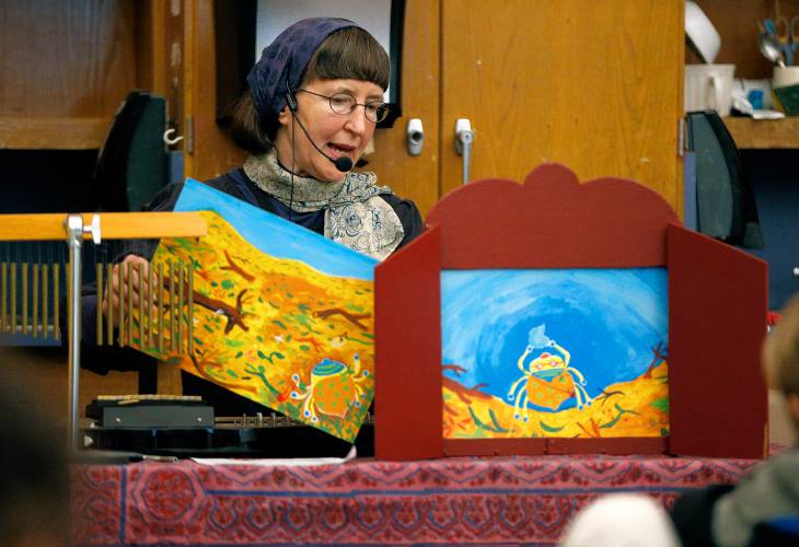 Music teacher Sue Matsui performs Kamishibai, a form of Japanese street theater and storytelling, Thursday during the annual International Night at Sunderland Elementary.