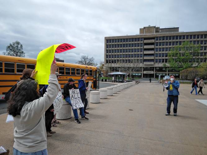 Ian Rhodewalt, a field organizer for the Western Mass Area Labor Federation, speaks during a debt cancellation rally Wednesday at the Haigis Mall at the University of Massachusetts Amherst.