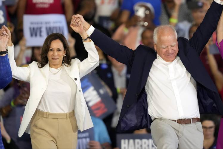 Democratic presidential nominee Vice President Kamala Harris and running mate Minnesota Gov. Tim Walz share their enthusiasm at a campaign rally on Aug. 7 in Romulus, Mich. Democratic presidential nominee Vice President Kamala Harris and running mate Minnesota Gov. Tim Walz share their enthusiasm at a campaign rally on Aug. 7 in Romulus, Mich.