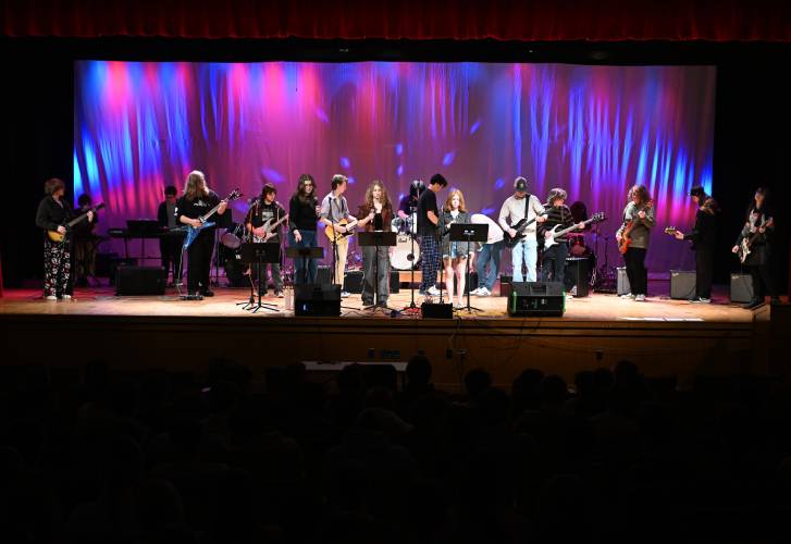 Members of the Frontier Modern Band Class and the Turners Falls High School Rock Club convene on stage at Frontier Regional School’s auditorium last week to perform for the student body in advance of a public concert held that evening.