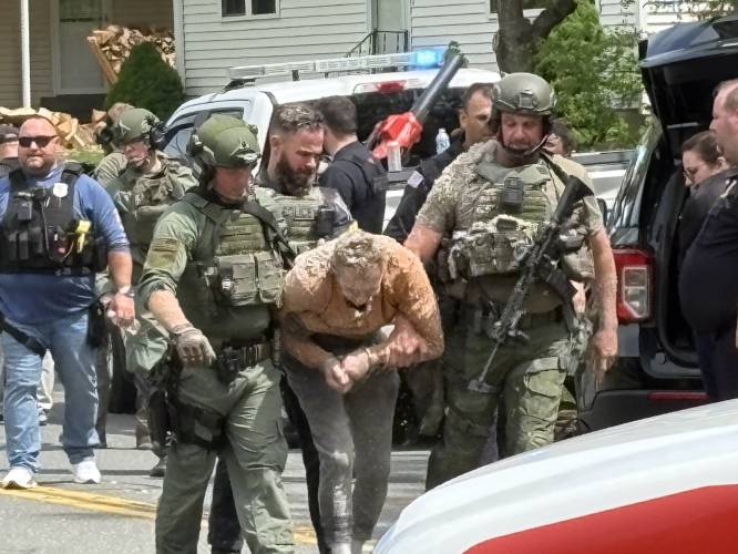 Franklin County Regional Response Team officers remove William Judd, of Greenfield, from an Elm Street house after six-hour police standoff on Friday.