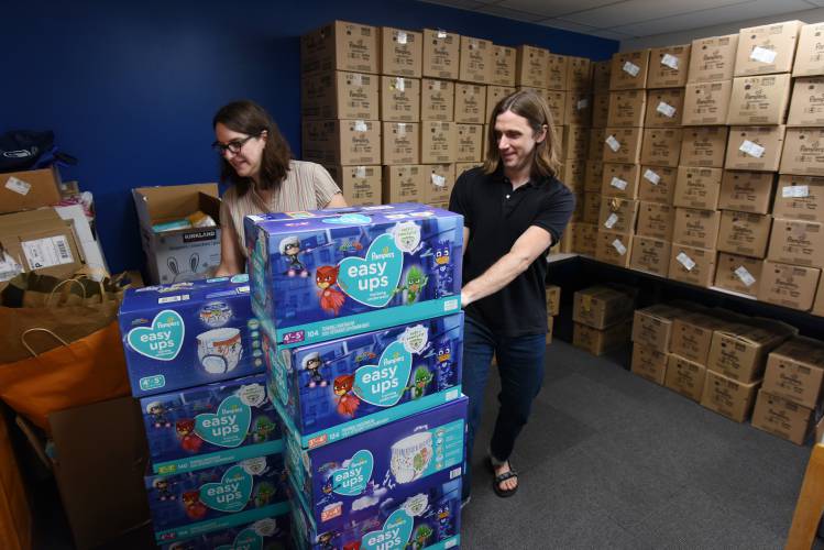 United Way of the Franklin & Hampshire Region Program Manager Jenny Coeur and Executive Director Geoff Naunheim, pictured with diapers at the Greenfield offices on Davis Street in 2022.