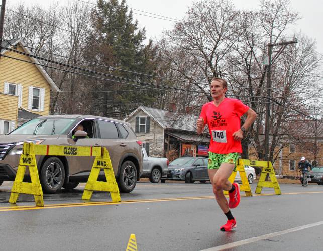 Owen Wright of Lakewood, Colorado about to cross the finish line as the winner of the Sawmill River 10k Run in Montague Center on New Years Day. This is the second Sawmill 10k the Amherst native has run, and the second time he's been the male overall winner. 