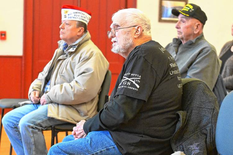 Arthur H. Phillips, a Purple Heart recipient from the Vietnam War, listens to his son, Selectboard Chair Clint Phillips, during a March 4 ceremony at Buckland Town Hall. At left is veteran John Chadwick, left, and veteran Doug March, right.