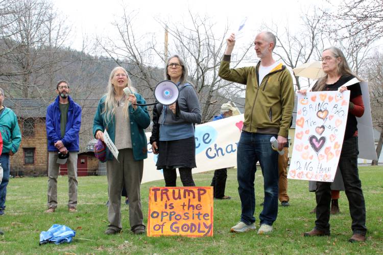 Sarah Pirtle leads protest chants across from the Buckland-Shelburne Community Center on Saturday.