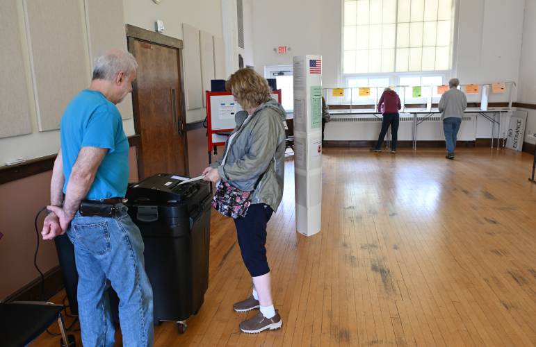 Resident Margaret Livingstone registers her ballot as election worker Bruce Kahn looks on at Northfield Town Hall on Tuesday. 