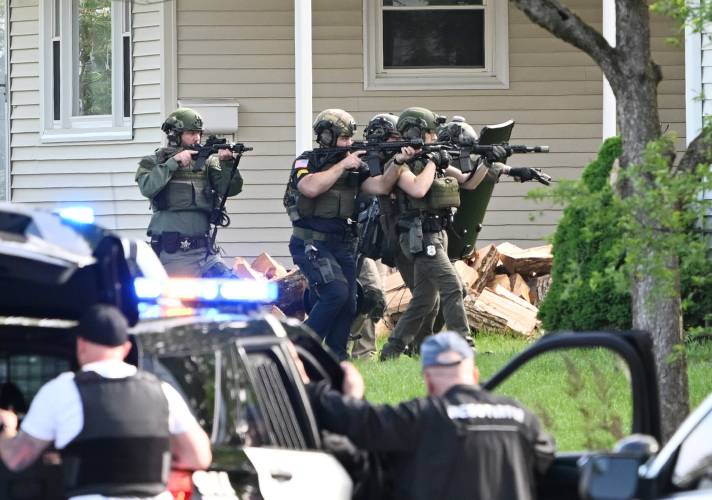 Members of the Franklin County Regional Special Response Team advance Friday morning on the home at 221 Elm St., where an alleged home invasion had taken place.