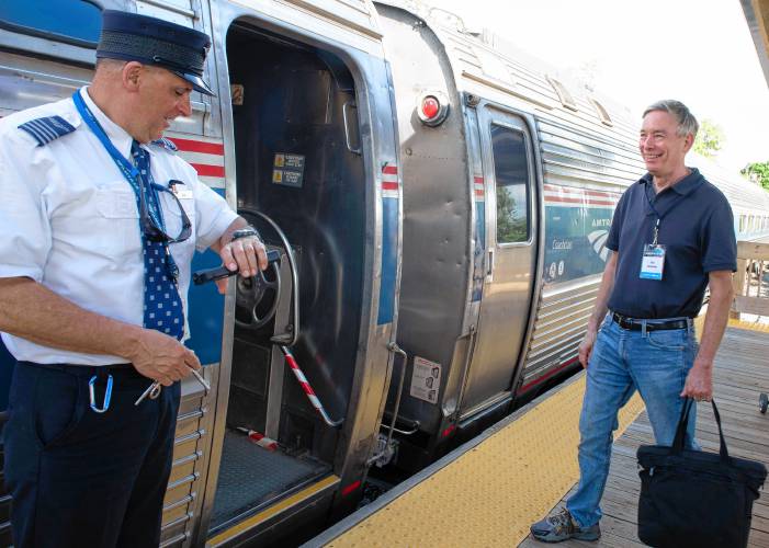 Ben Heckscher, co-founder of Trains in the Valley, gets ready to board the Valley Flyer as it makes its stop in Northampton on Tuesday evening. 