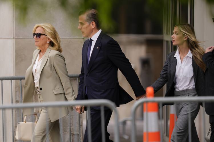 Hunter Biden, center, President Joe Biden's son, accompanied by his mother, first lady Jill Biden, left, and his wife, Melissa Cohen Biden, right, walking out of federal court after hearing the verdict, Tuesday, June 11, 2024, in Wilmington, Del. Hunter Biden has been convicted of all 3 felony charges in the federal gun trial. (AP Photo/Matt Rourke)