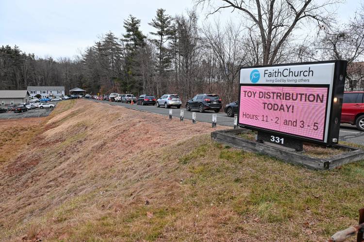Vehicles line up to receive Christmas gifts as part of the Giving Back Together Toy Drive at Faith Church on Silver Street in Greenfield on Friday.