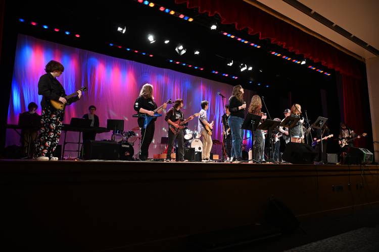 Members of the Frontier Modern Band Class and the Turners Falls High School Rock Club convene on stage at Frontier Regional School’s auditorium last week to perform for the student body in advance of a public concert held that evening.