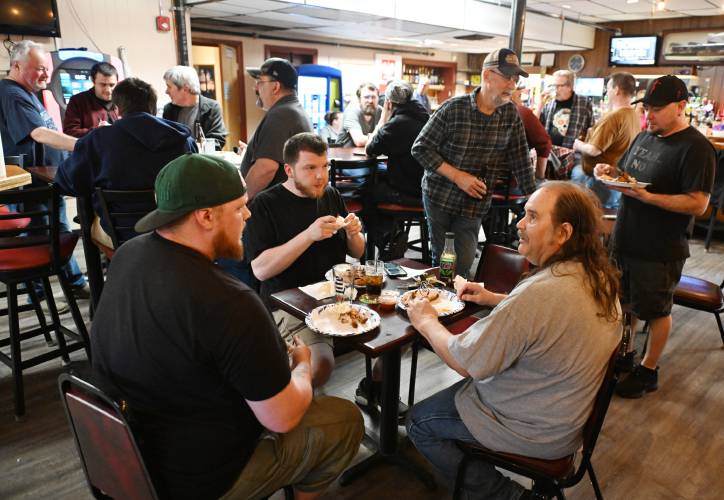 Former Kennametal employees gathered at St. Kazimierz Society in Turners Falls for pizza and chicken wings after their final shifts on Tuesday.