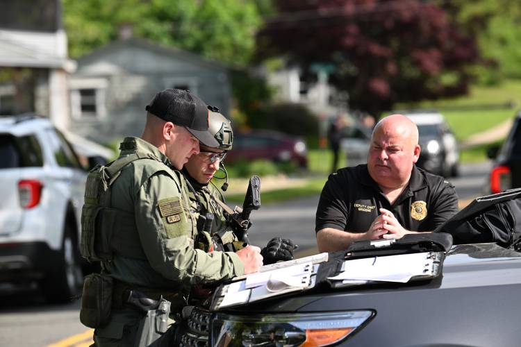 Greenfield Deputy Chief Christopher Greene, right, talks with members of the Franklin County Regional Special Response Team.