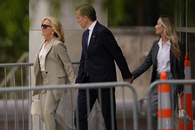 Hunter Biden, center, President Joe Biden's son, accompanied by his mother, first lady Jill Biden, left, and his wife, Melissa Cohen Biden, right, walking out of federal court after hearing the verdict, Tuesday, June 11, 2024, in Wilmington, Del. Hunter Biden has been convicted of all 3 felony charges in the federal gun trial. (AP Photo/Matt Rourke)