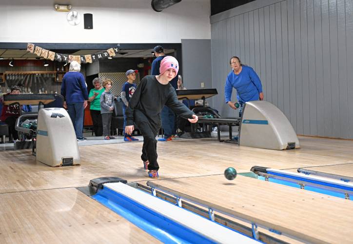 Ben Merriett, 12, lets one fly at the candlepins as he bowls at the French King Bowling Center in Erving.