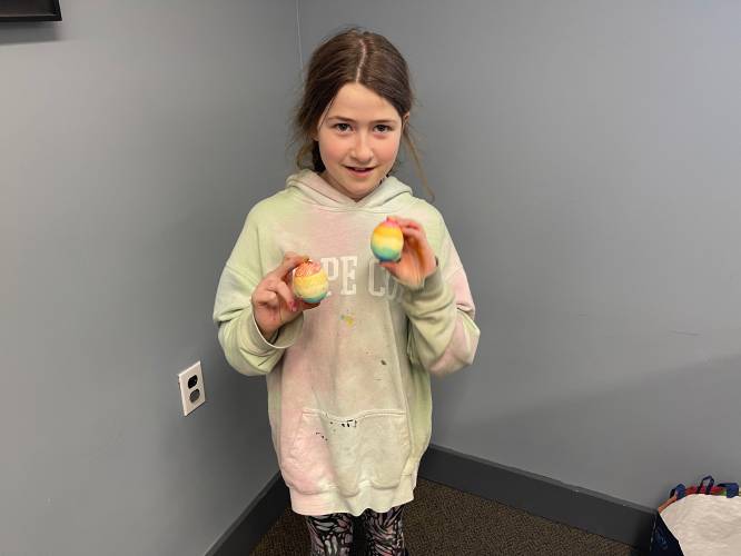 Ida Westley, 10, of Ashfield, smiles with her rainbow egg art.