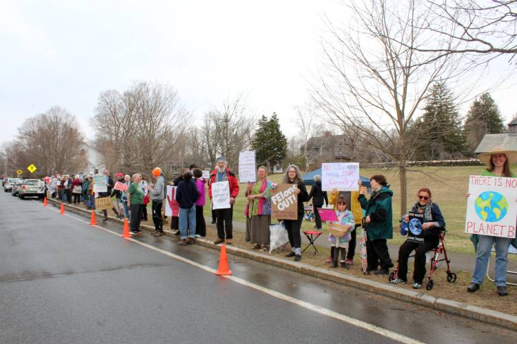 Protesters stand on the Ashfield town common on Saturday in opposition to the Trump administration.