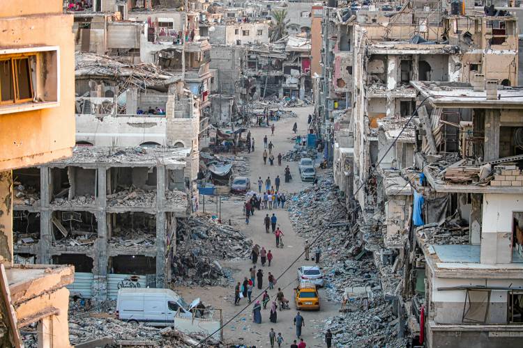 Palestinians displaced by the Israeli bombardment of the Gaza Strip walk through a street market in Khan Younis, in southern Gaza Strip, on June 29.
