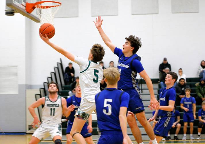Greenfield’s Grayson Thomas (5) stretches for a layup against Wahconah in the first quarter Saturday night in Greenfield.